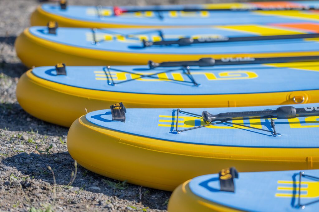 Paddleboards and paddles laid out before a beginner SUP session in Tri-Cities WA